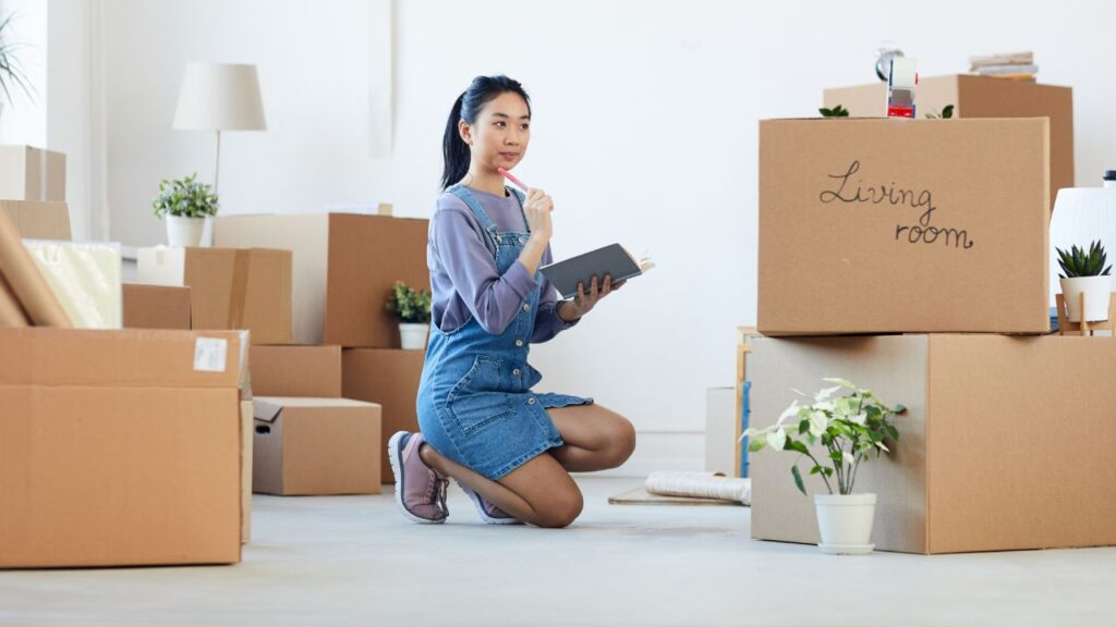 girl organizing apartment with boxes