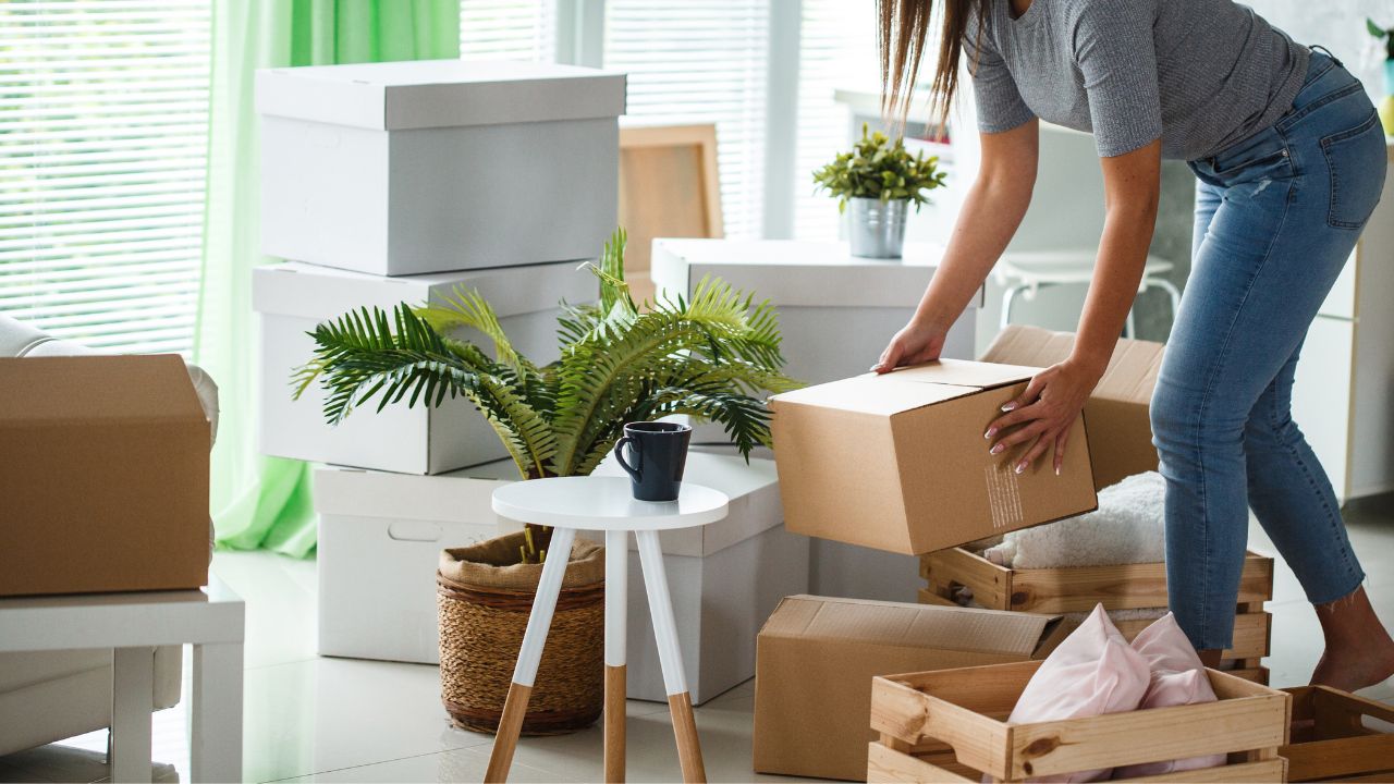 woman boxing apartment clutter