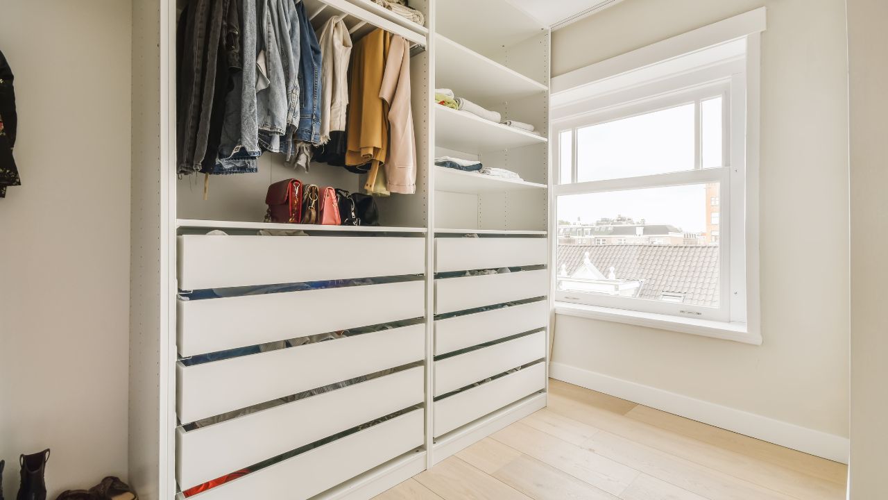 closet space with a few clothes hanging and drawers