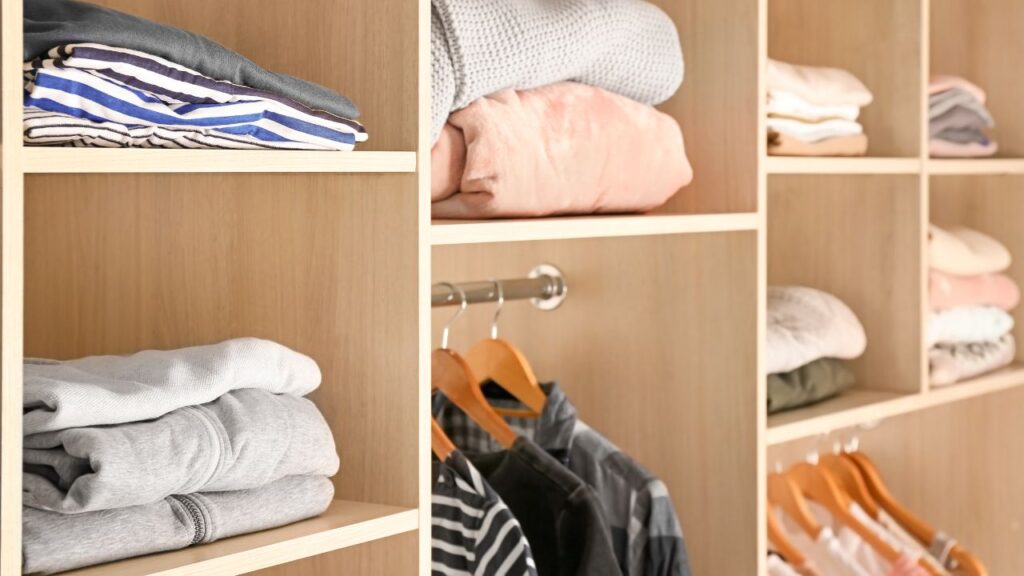 organized closet with hanging and folded clothes