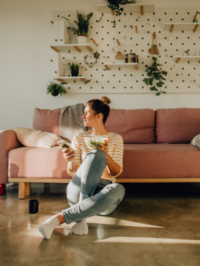 woman-sitting-in-front-couch-eating-salad-story