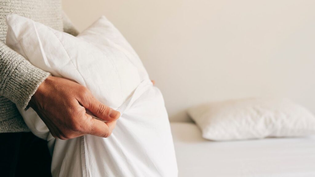 person making the bed