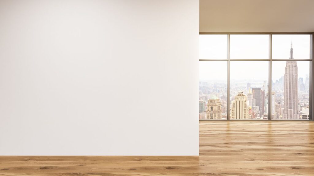 empty apartment with big window looking out into the city