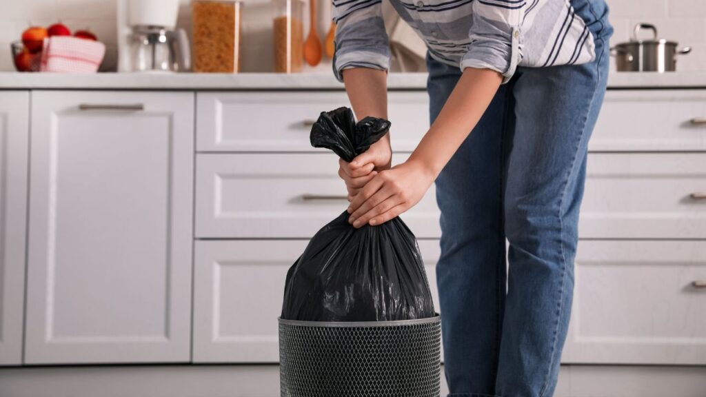 emptying kitchen trash can