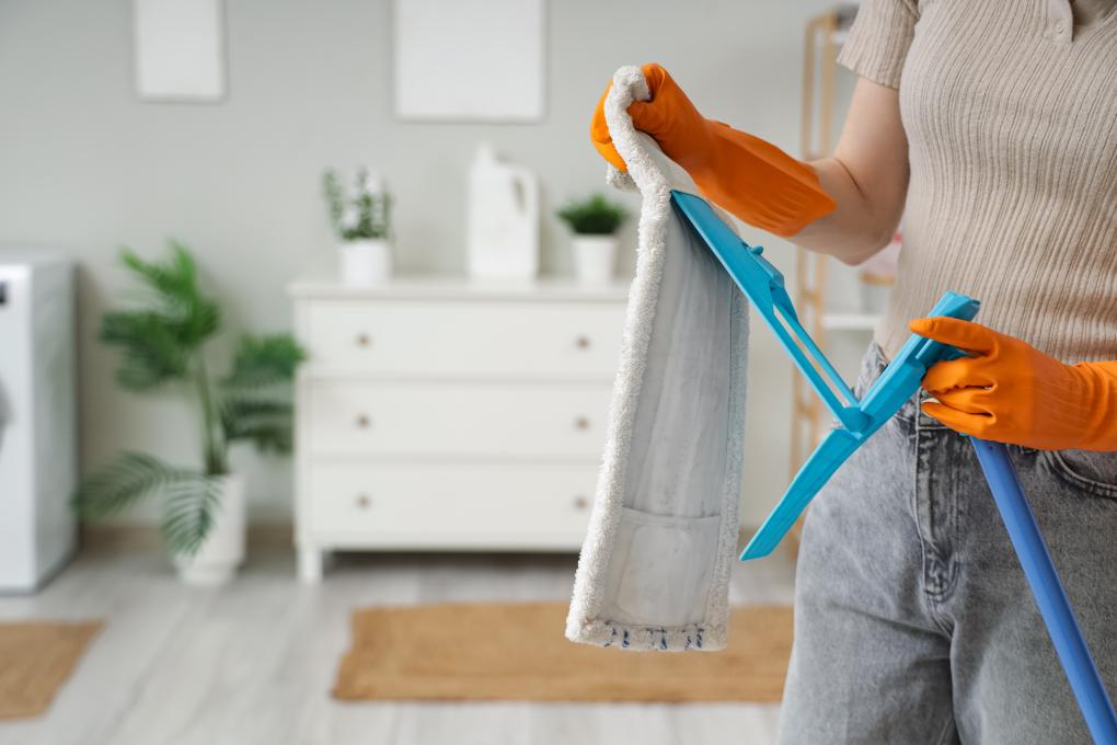 Woman changing mop to clean