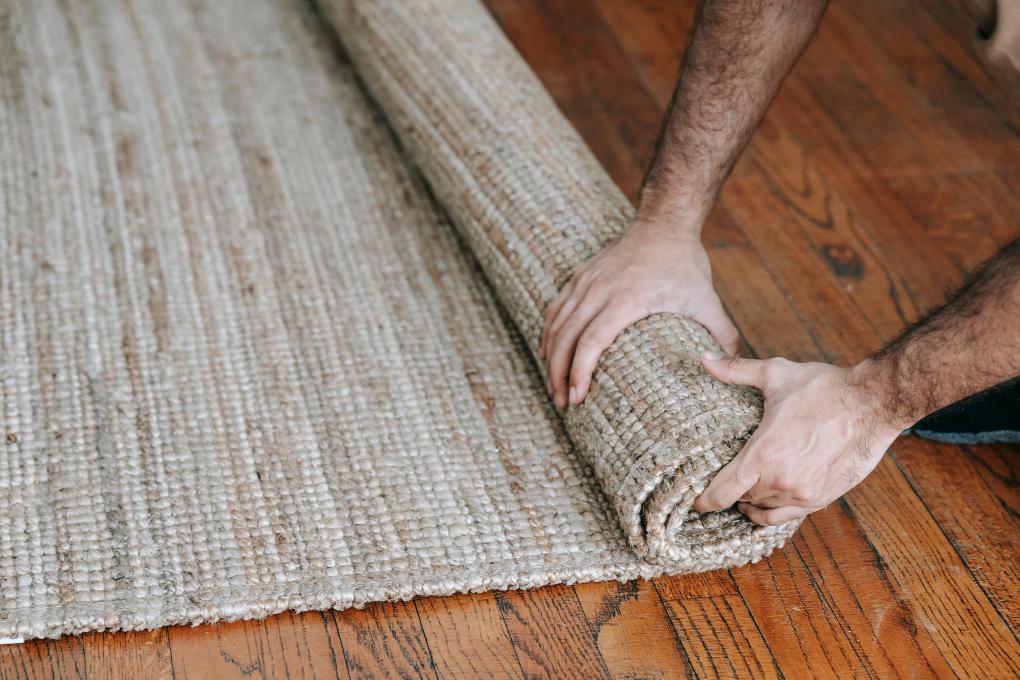hands rolling a carpet