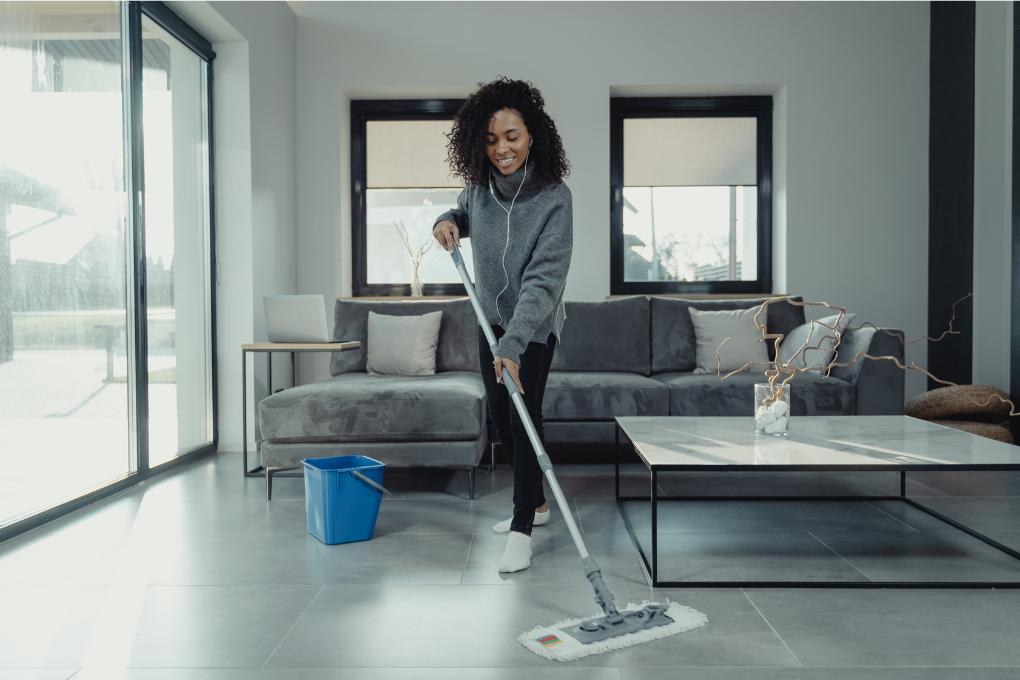 young woman mopping room