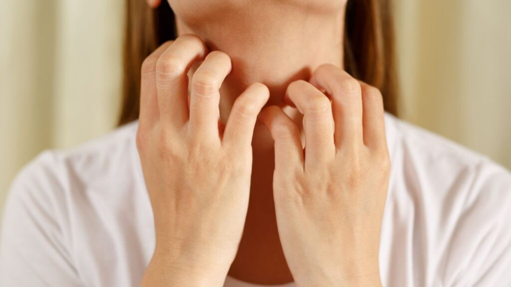 woman scratching neck